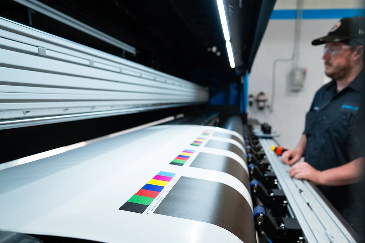 schneller-employee-focused-working-on-a-printing-machine