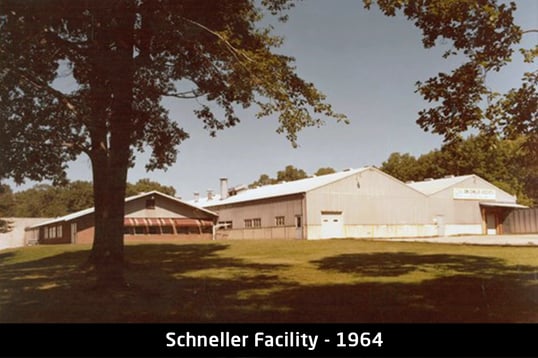 aerial-view-of-first-schneller-facility-large-factory-building-surrounded-by-trees
