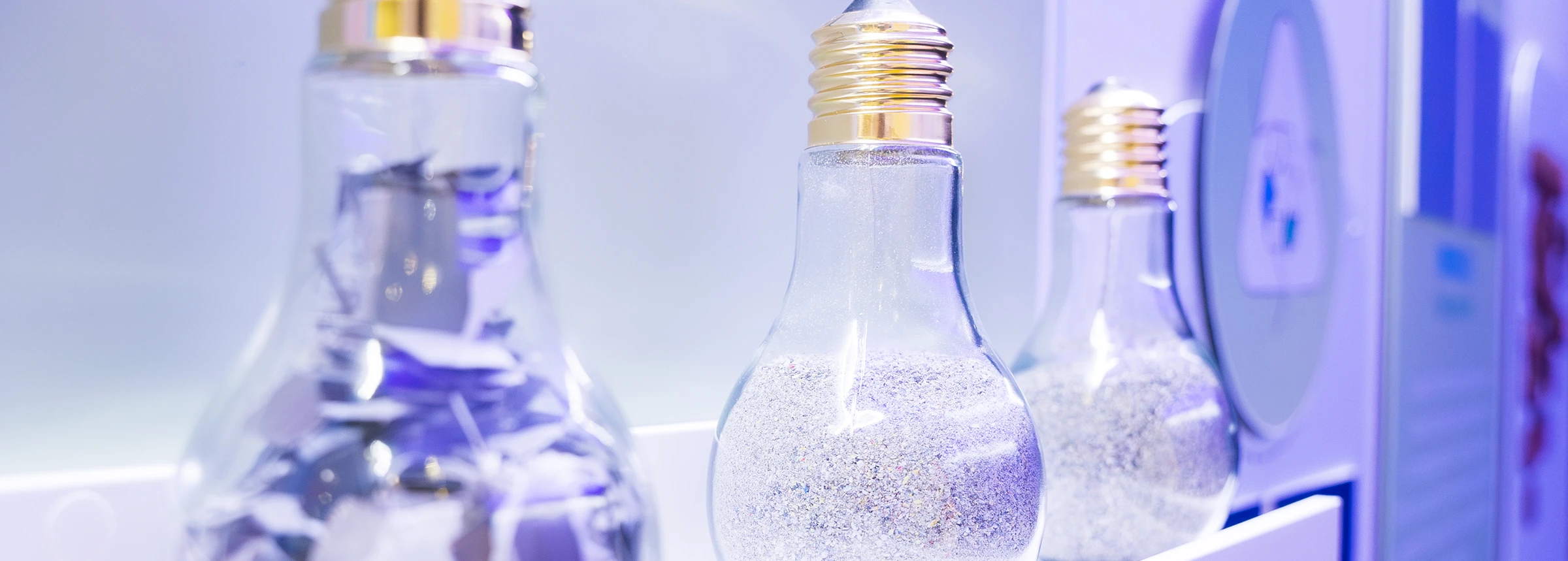 detailed-view-of-three-lightbulbs-filled-with-recycled-material